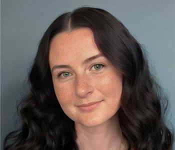 Woman with dark hair and white shirt