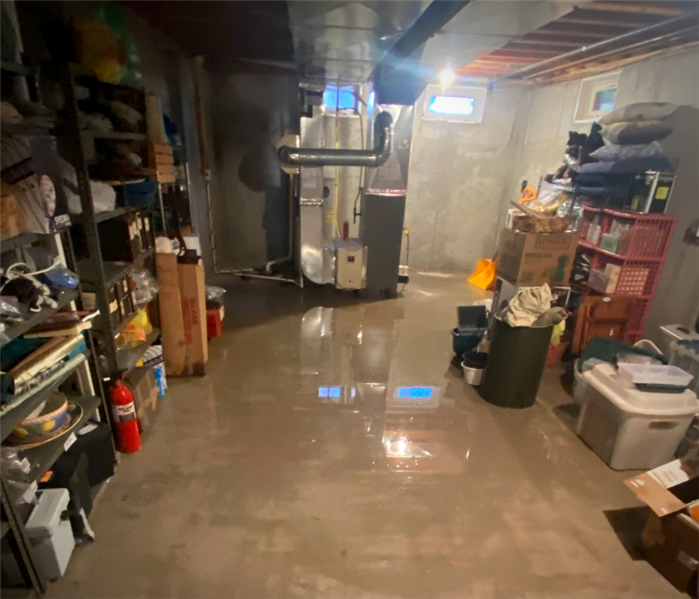 water heater flooded basement. standing water in front of furnace and water heating in basement